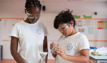 AKA Maputo students work on a science experiment together.